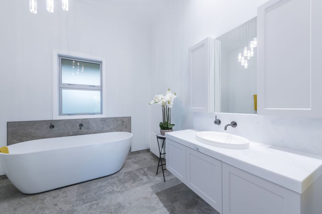 Villa bathroom after renovation with freestanding bath and white vanity