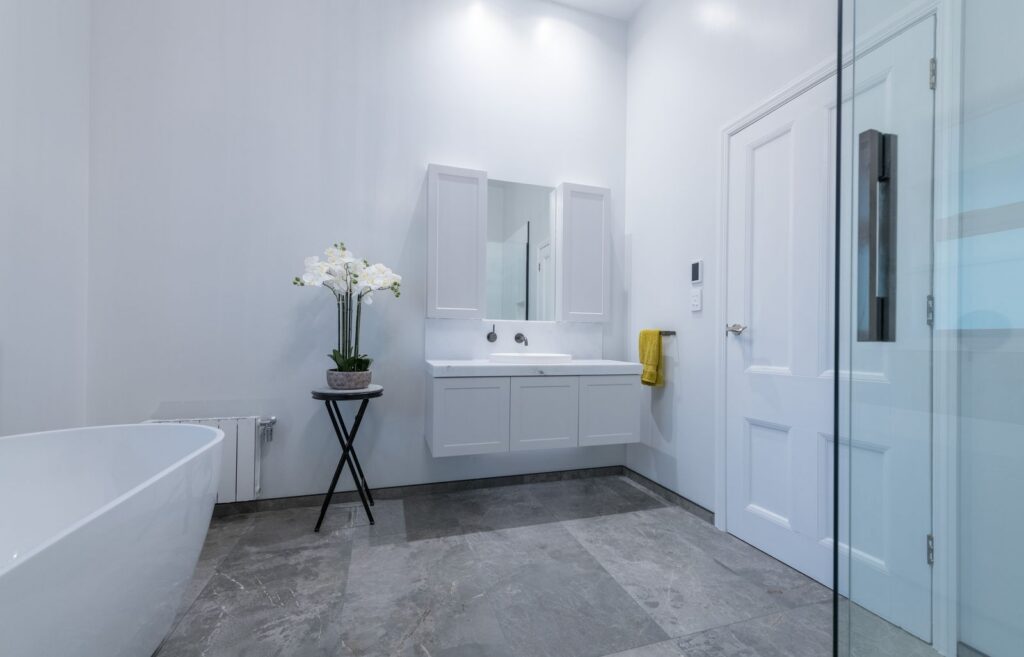 Renovated villa bathroom with walk in shower and freestanding bath