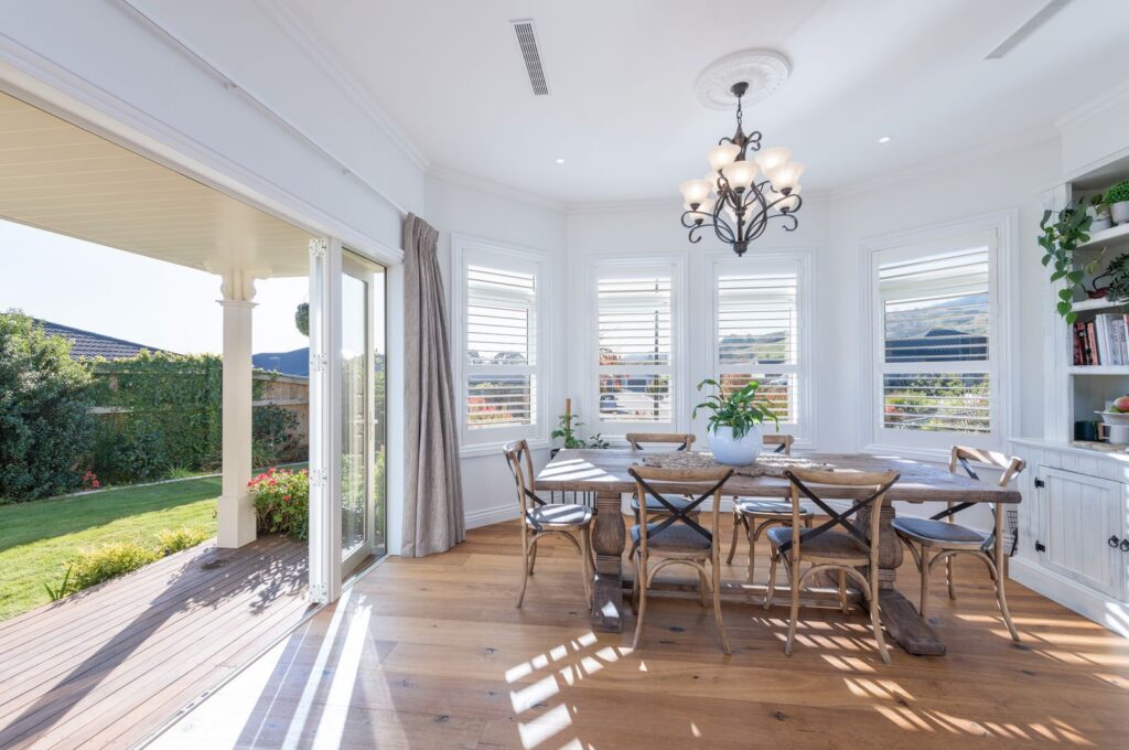 Bay window dining room with chandelier at Marionberry Lane