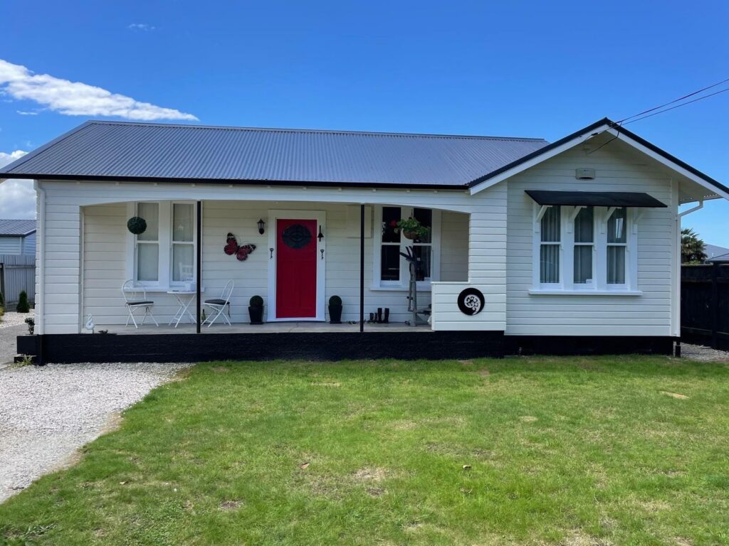The same cottage after a new roof, cladding repairs and fresh paint