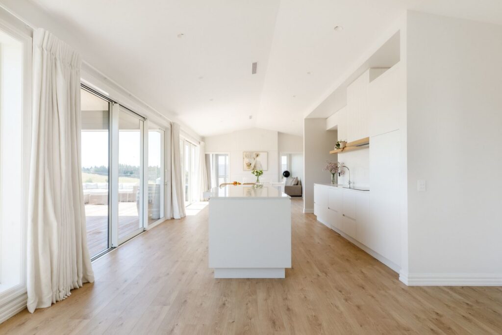Open plan living area at Redvale Estate with sliding doors to the deck