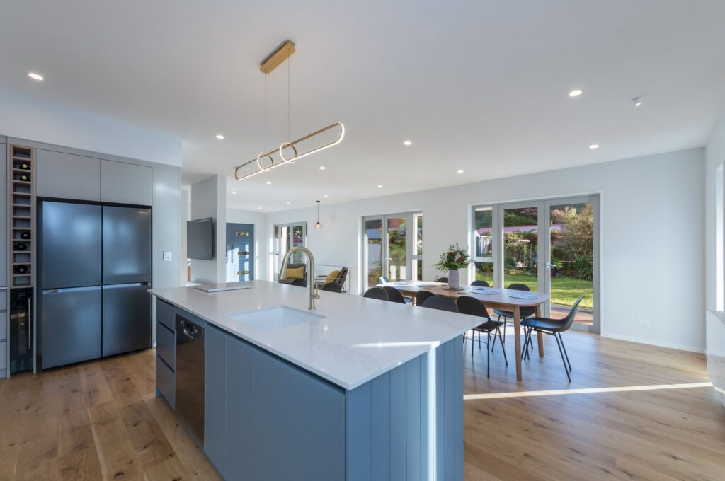 Kitchen island and dining in the Takaka Hill villa renovation