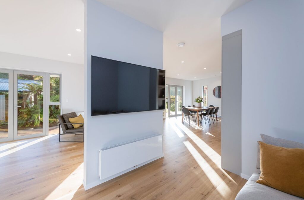 Light filled living room with oak floors in the Takaka Hill renovation